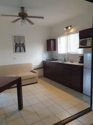 a living room with a couch and a kitchen at Apart Hotel Marina Loft 214 in Coco