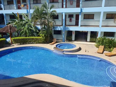 a large swimming pool in front of a building at Apart Hotel Marina Loft 214 in Coco