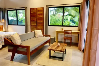 a living room with a couch and a table at La Joya de Nosara in Playa Pelada