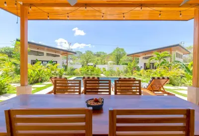 a dining room with a table and chairs at La Joya de Nosara in Playa Pelada