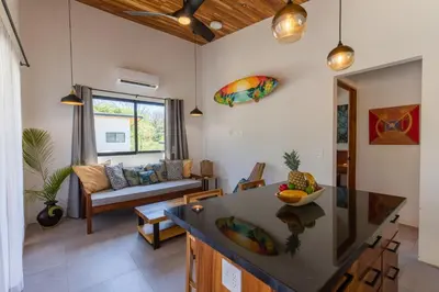 a living room with a couch and a table at La Joya de Nosara in Playa Pelada