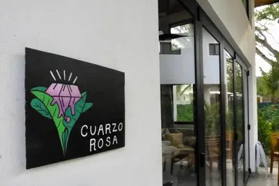 a sign for a restaurant on the side of a building at La Joya de Nosara in Playa Pelada