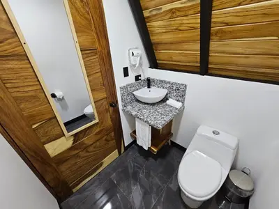 a small bathroom with a toilet and a sink at Wind Houses, Casas de Viento in Monteverde Costa Rica