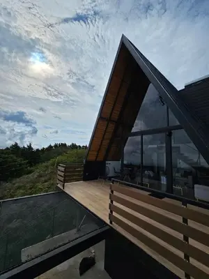 a house with a large deck with a view at Wind Houses, Casas de Viento in Monteverde Costa Rica