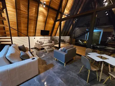 a living room with a couch and chairs and a table at Wind Houses, Casas de Viento in Monteverde Costa Rica
