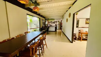a large dining room with a long table and chairs at Hostel El Pretal in Liberia