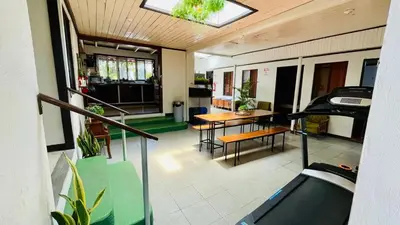 a room with a balcony with a table and chairs at Hostel El Pretal in Liberia