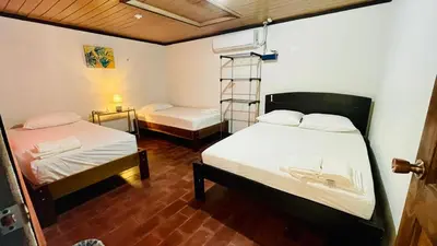 a room with two beds and a ladder in it at Hostel El Pretal in Liberia