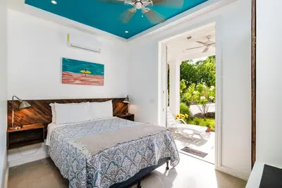 a bedroom with a bed and a ceiling fan at Buendía Lux Piña Suite Hidden Gem Near Beach with Pool in Potrero