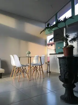 a dining room with a table and white chairs at Casa céntrica en San Ramón in San Ramón