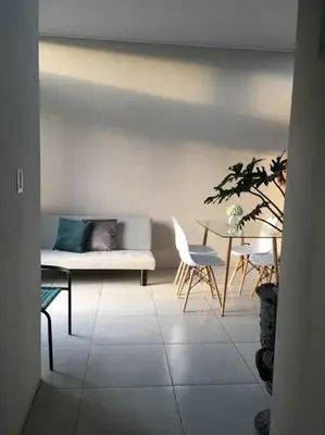 a living room with a couch and a table at Casa céntrica en San Ramón in San Ramón