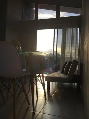 a dining room with a table and chairs and a window at Casa céntrica en San Ramón in San Ramón