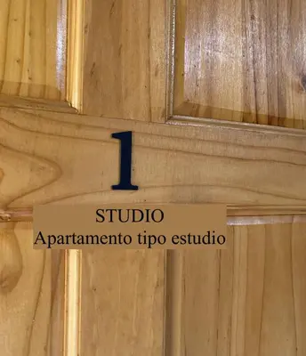 a sign on a wooden door with the number on it at Apartamentos Sacor #1 Studio in Curridabat