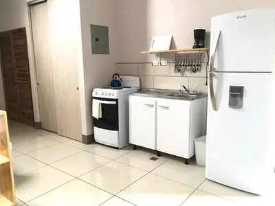 a kitchen with a white stove and a refrigerator at Apartamentos Sacor #1 Studio in Curridabat