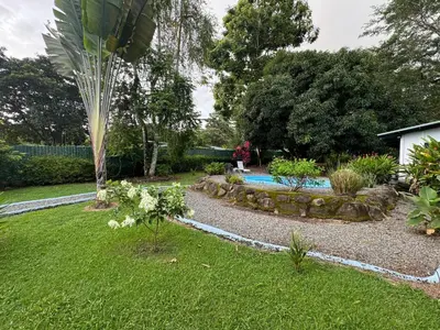 a garden with a swimming pool in a yard at Casa Willow Spacious and relaxing property in Ojochal