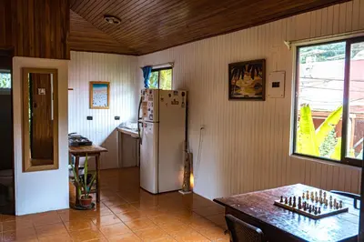a kitchen with a refrigerator and a table at Surf Paradise in Santa Teresa Beach