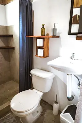 a bathroom with a toilet and a sink at Surf Paradise in Santa Teresa Beach