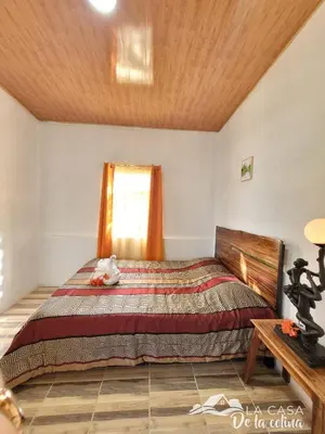 a bedroom with a bed and a window at Vista al Volcán Tenorio y Montaña in San Rafael