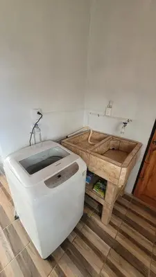 a bathroom with a white toilet and a sink at Vista al Volcán Tenorio y Montaña in San Rafael