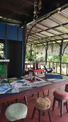 a large table with chairs in a room at Vista Alta Ecolodge Bahia Drake in Drake