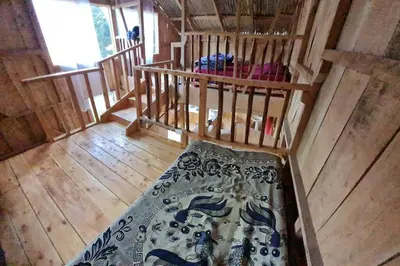 an overhead view of a bedroom in a wooden cabin at Cabaña El Descanso #1, Macho Mora Mountain Lodge in Alaska