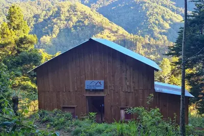 a large wooden barn with a sign on it at Cabaña El Descanso #1, Macho Mora Mountain Lodge in Alaska