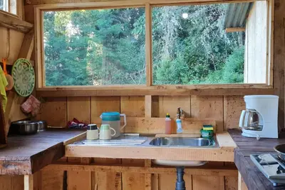 a kitchen counter with a sink and a window at Cabaña El Descanso #1, Macho Mora Mountain Lodge in Alaska