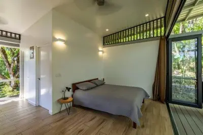 a bedroom with a bed and a large window at Nangu lodge in Sámara