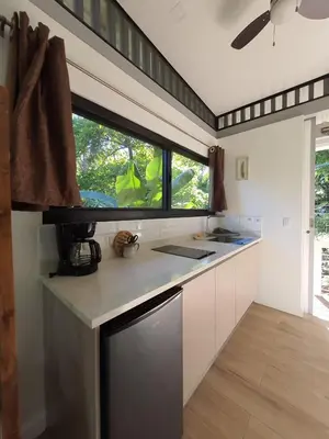 a kitchen with a counter and a window in it at Nangu lodge in Sámara