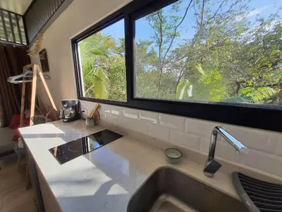 a kitchen with a sink and a large window at Nangu lodge in Sámara