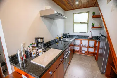a kitchen with a sink and a counter top at Sloth Premium Riverfront Jungle Villa with Jacuzzi and Pool in Uvita