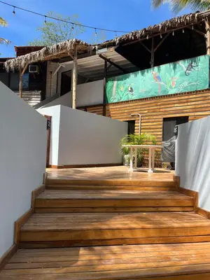 a wooden deck with stairs in front of a house at Quinta Esencia in Brasilito
