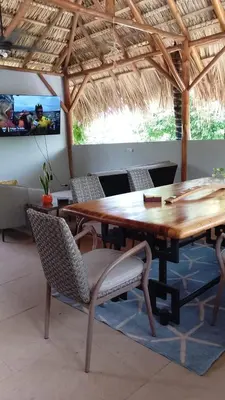a wooden table and chairs in a pavilion at Quinta Esencia in Brasilito