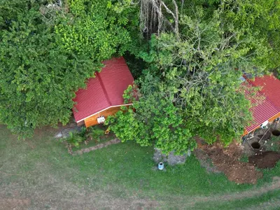 an overhead view of a house with a red roof at Cabañas Del Lago . Bungalows in San Ramón