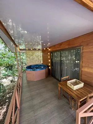 a balcony of a house with a hot tub at Cabañas Del Lago . Bungalows in San Ramón