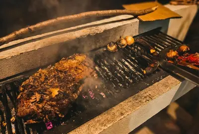 a grill with meat and other food on it at Pura Vida - Villa Elenita in Parrita