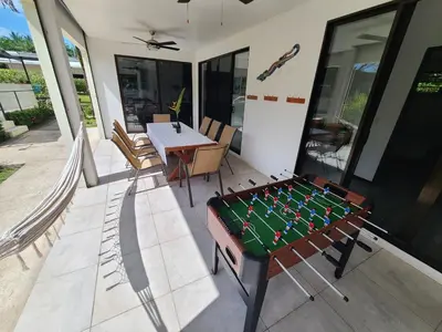 a pool table on a balcony with a table at Pura Vida - Villa Elenita in Parrita