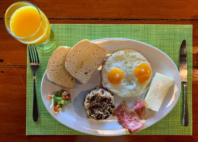 a plate of breakfast food with an egg and toast at Las Caletas Lodge in Drake