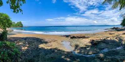 a sandy beach with the ocean in the background at Las Caletas Lodge in Drake