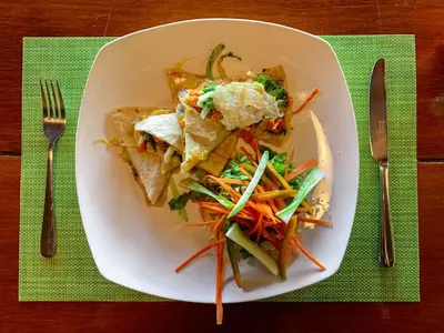 a white plate of food on a table at Las Caletas Lodge in Drake