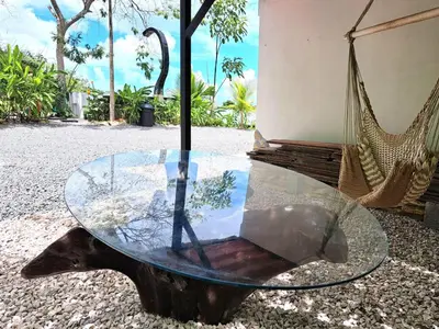 a glass table with a swing and a hammock at Casa Namaste del Pacifico - Luxury Villa in Santa Teresa Beach