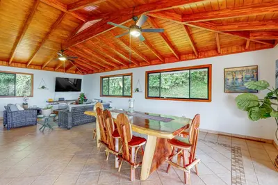 a dining room with a table and chairs at Casa Garrobo in Dominical