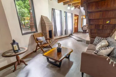 a living room with a couch and a table at Casa Violeta Home rentals in Monteverde Costa Rica
