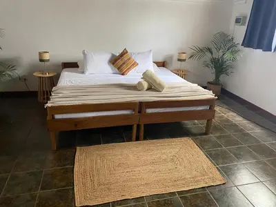 a bedroom with a bed with pillows on it at Dream Surf House Avellana in Playa Avellana