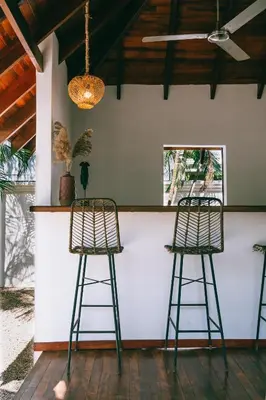 two chairs sitting at a bar in a room at Dream Surf House Avellana in Playa Avellana