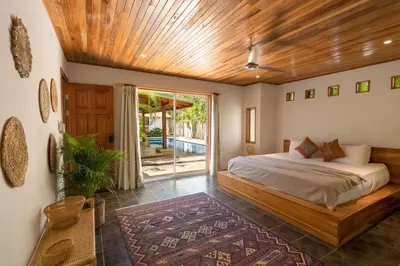 a bedroom with a bed with a wooden ceiling at Dream Surf House Avellana in Playa Avellana
