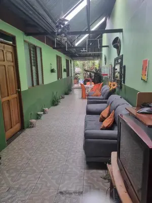 a living room with couches in a room at Hotel Paradise Alajuela in Alajuela City