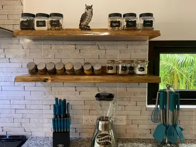 a cat sitting on a shelf above a brick wall at Golf Beach House w/ Pool (5 min. walk to beach!) in Tambor