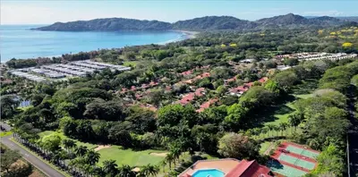 an aerial view of a resort next to the ocean at Golf Beach House w/ Pool (5 min. walk to beach!) in Tambor