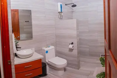 a small bathroom with a toilet and a sink at Villa Aurora with Jacuzzi in La Fortuna in Fortuna